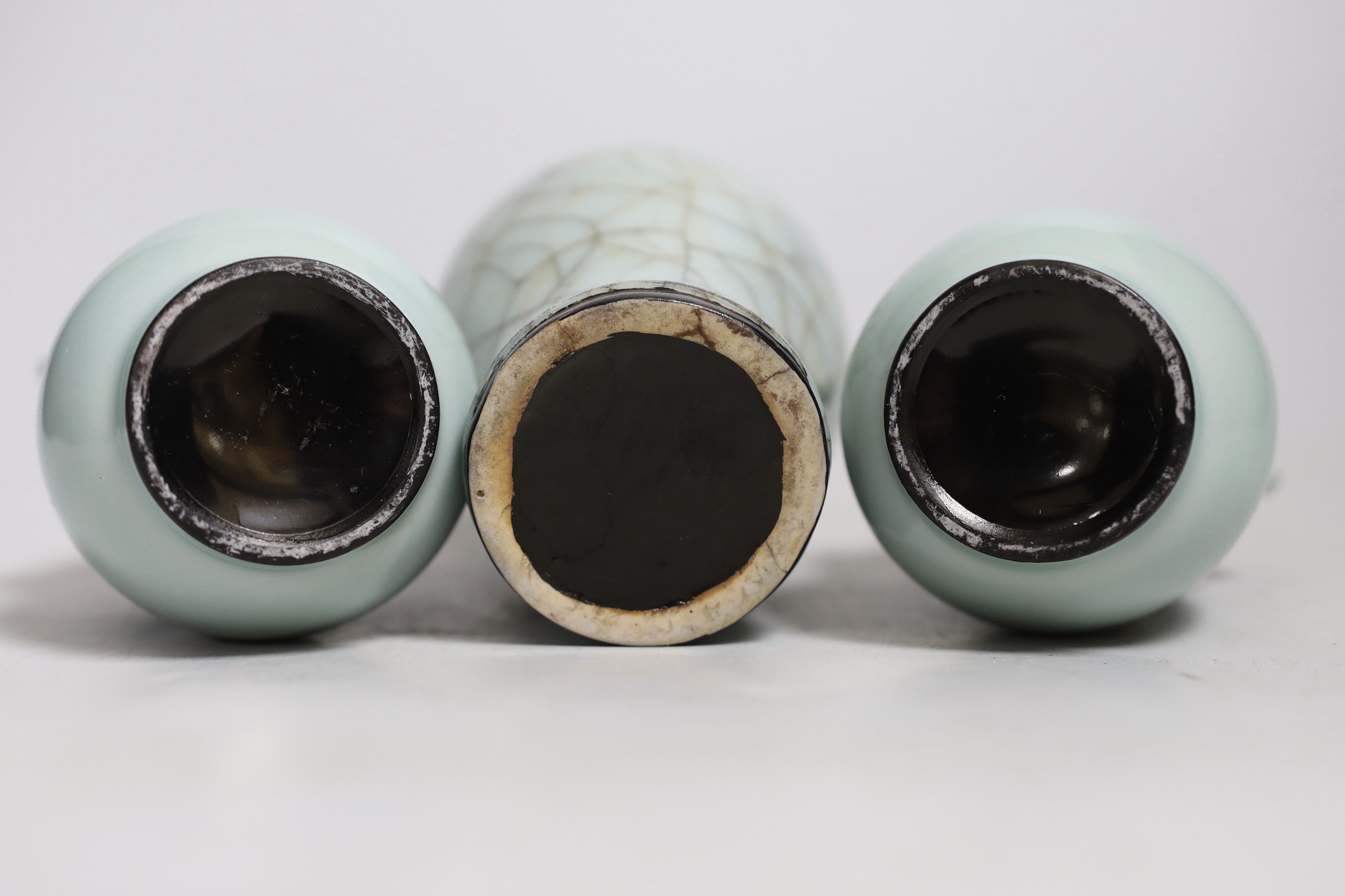 A Chinese celadon crackle ware vase and a pair of smaller celadon vases, largest 16.cms